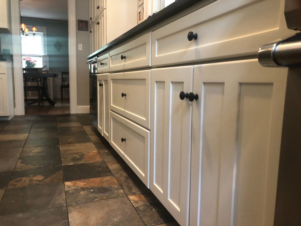 white kitchen cabinets with black knobs