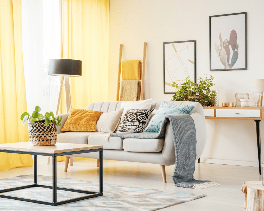 warm room with yellow curtains and a neutral tan wall. 